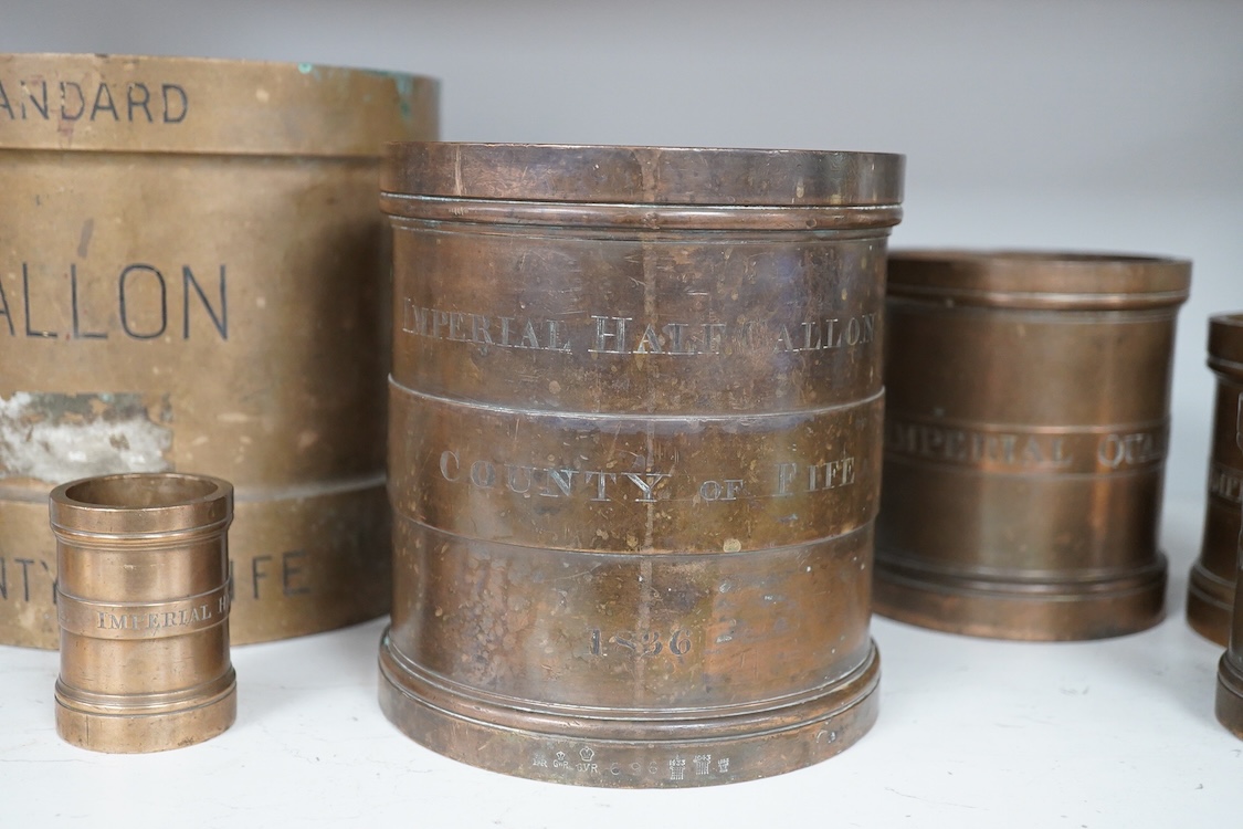 A set of seven early 20th century County of Fife official measures, comprising; a standard gallon, diameter 19.5cm, height 18.5cm, Imperial half gallon, Imperial quart, Imperial pint, Imperial half pint, Imperial gill, I